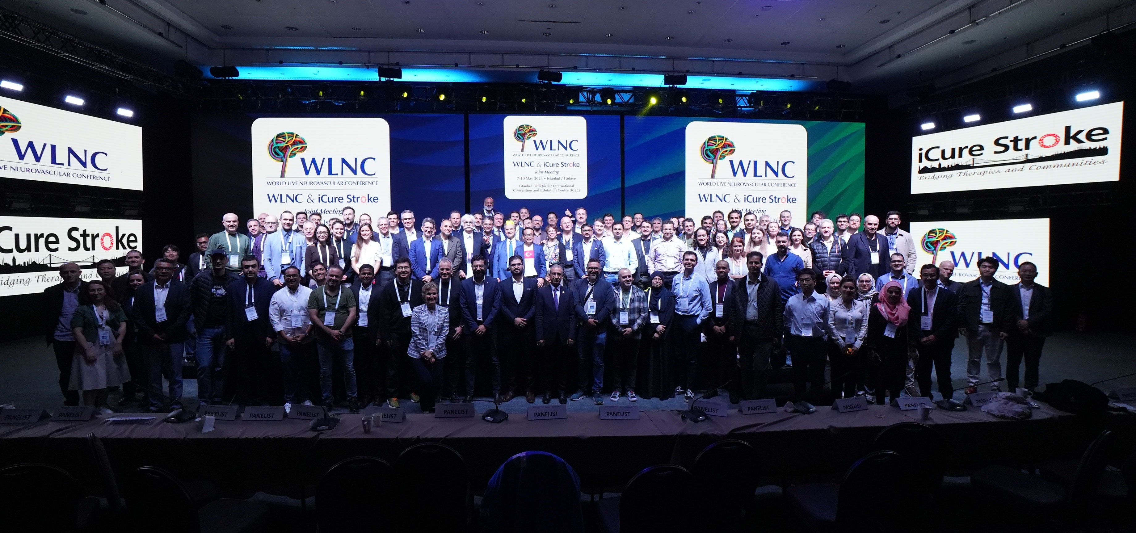 Group photo of global participants, faculty, and panelists on stage at WLNC & iCure Stroke 2024 Joint Meeting in Istanbul